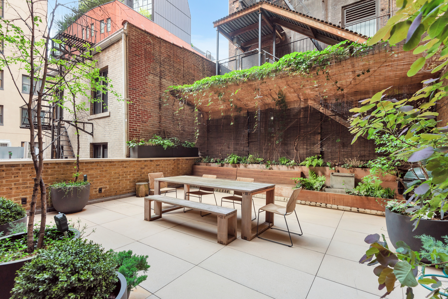 17 East 12th Street, Unit 2 Manhattan, NY 10003 - Photo 16 of 19 a view of a patio with table and chairs under an umbrella