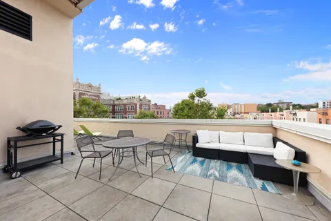 a view of a terrace with furniture and a terrace view