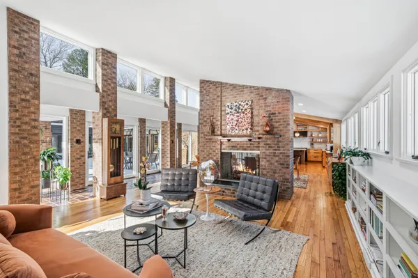 a living room with furniture and large windows