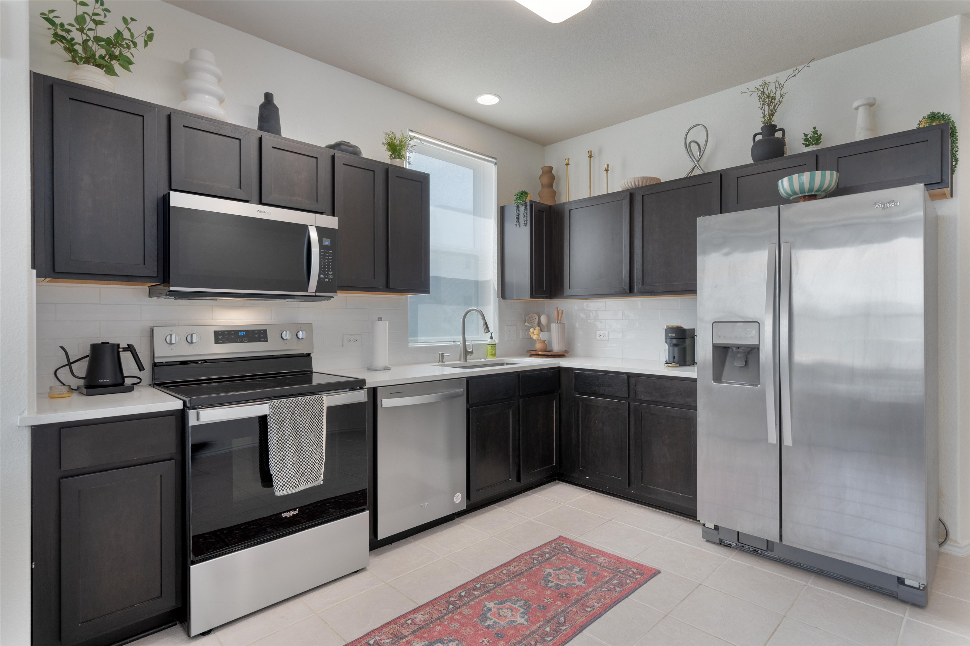4330 Olenick Street Austin, TX 78723 - Photo 20 of 29 a kitchen with stainless steel appliances granite countertop a refrigerator and a stove top oven