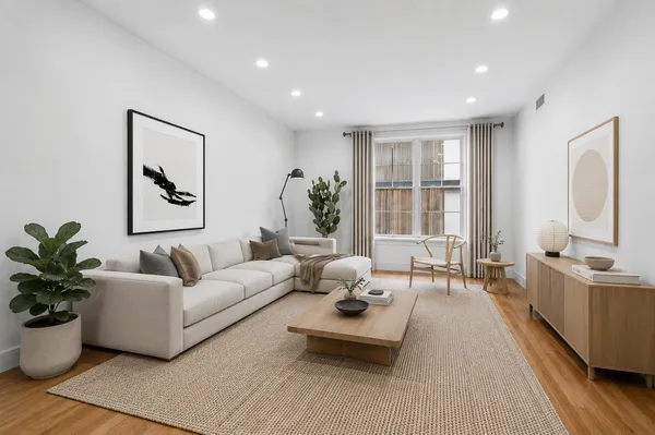 a living room with furniture potted plant and windows