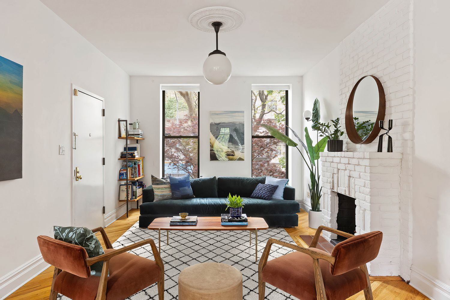a living room with furniture a fireplace and a chandelier