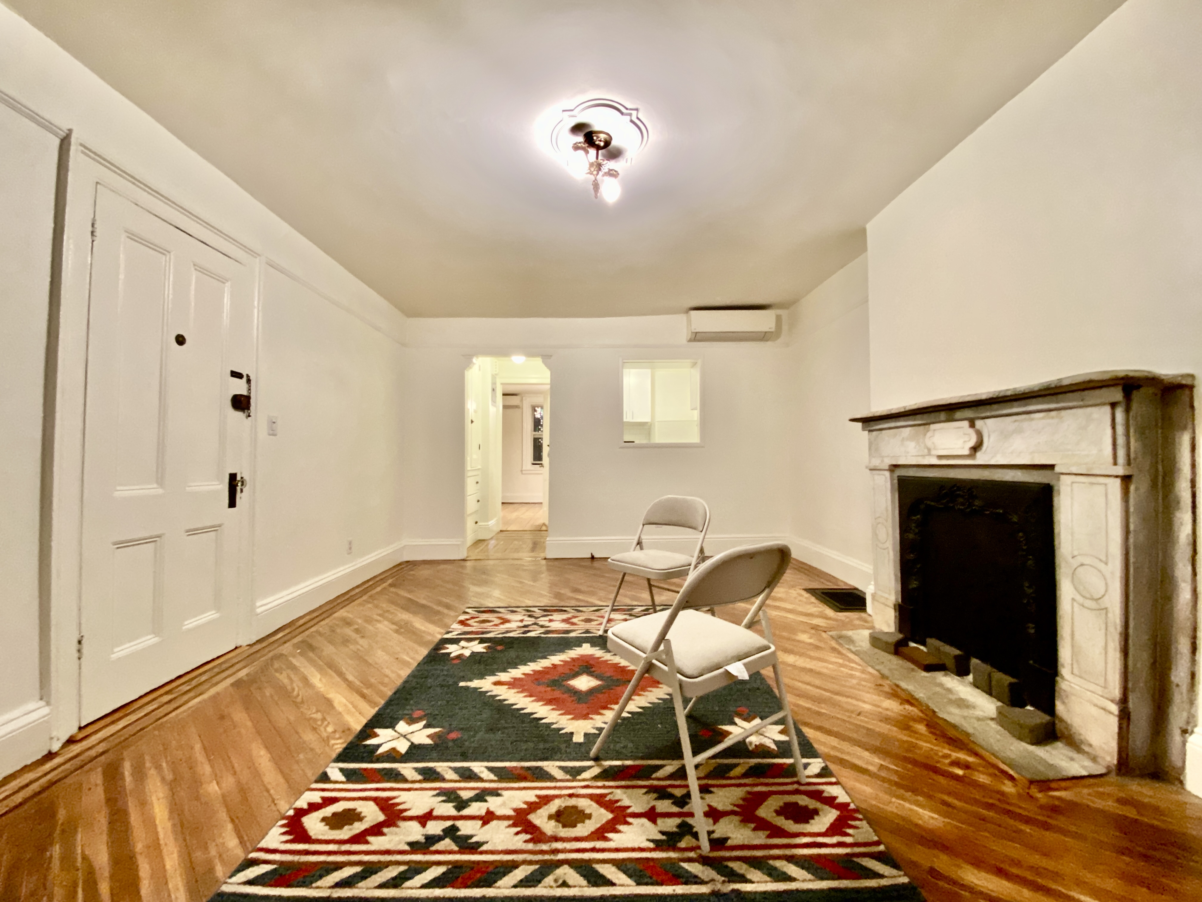 119 Gates Avenue, Unit 1 Brooklyn, NY 11238 - Photo 2 of 11 a bedroom with a bed and wooden floor