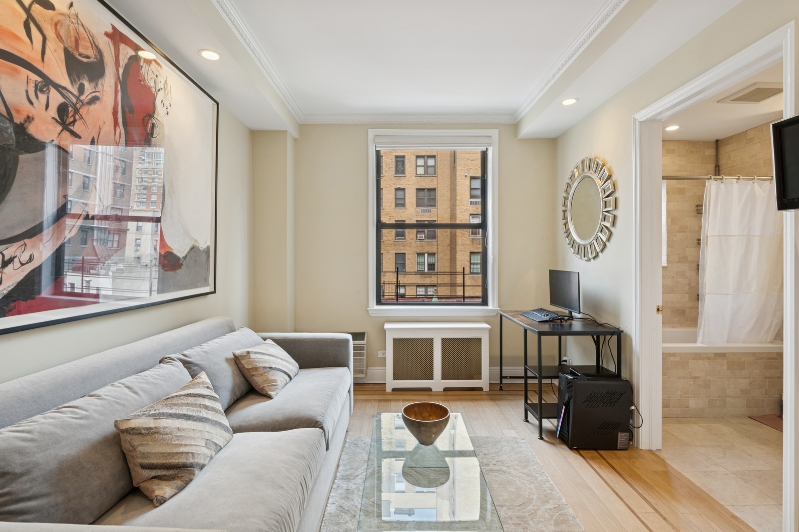 514 West End Avenue, Unit 8/9A Manhattan, NY 10024 - Photo 8 of 24 a living room with furniture a flat screen tv and a window