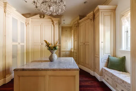 a bathroom with a granite countertop sink a mirror and shower