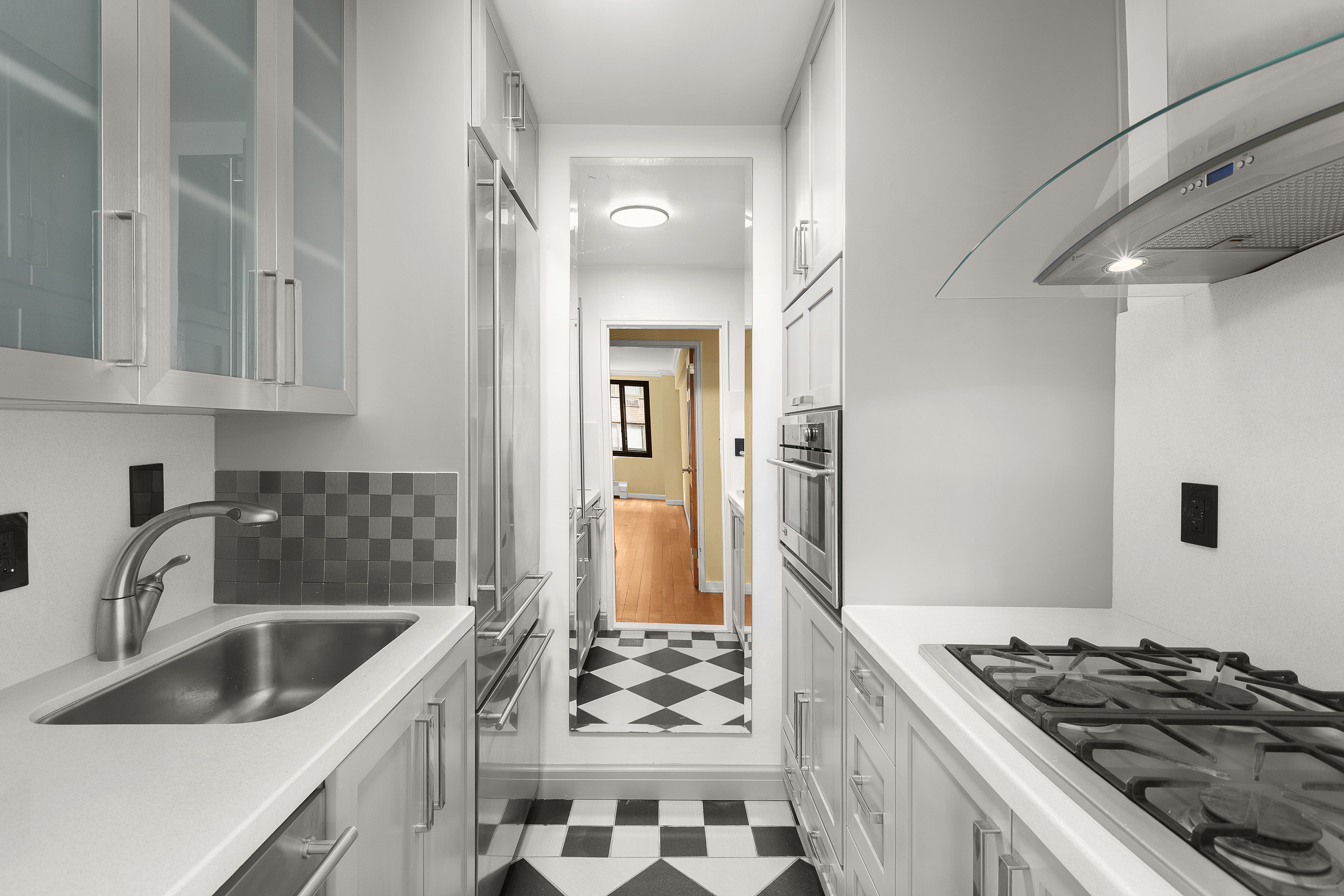 425 East 63rd Street, Unit E7A Manhattan, NY 10065 - Photo 4 of 13 a kitchen that has a sink and a stove