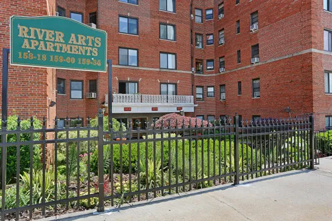 a front view of a multi story building with a yard