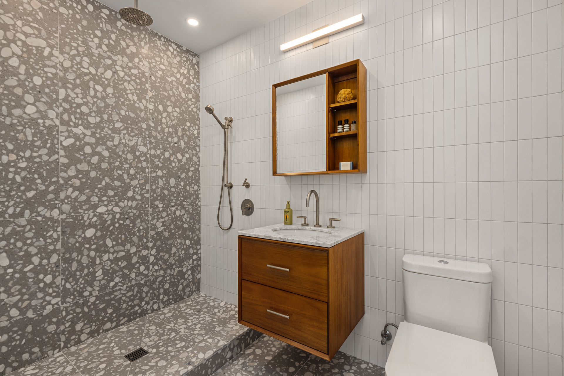 584 Leonard Street, Unit PHB Brooklyn, NY 11222 - Photo 16 of 22 a bathroom with a toilet sink vanity and mirror