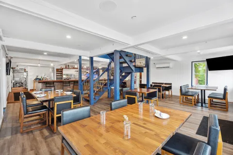 a living room with lots of furniture and wooden floor