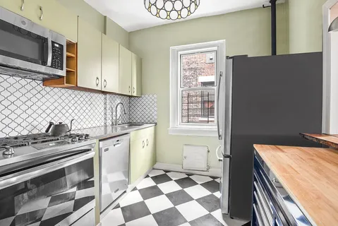 a kitchen with a stove a sink and a refrigerator