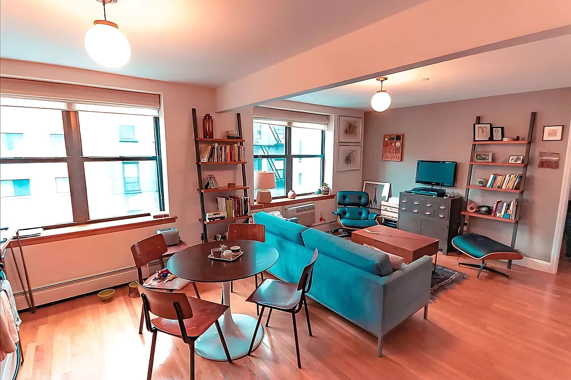 a living room with furniture a flat screen tv and a large window