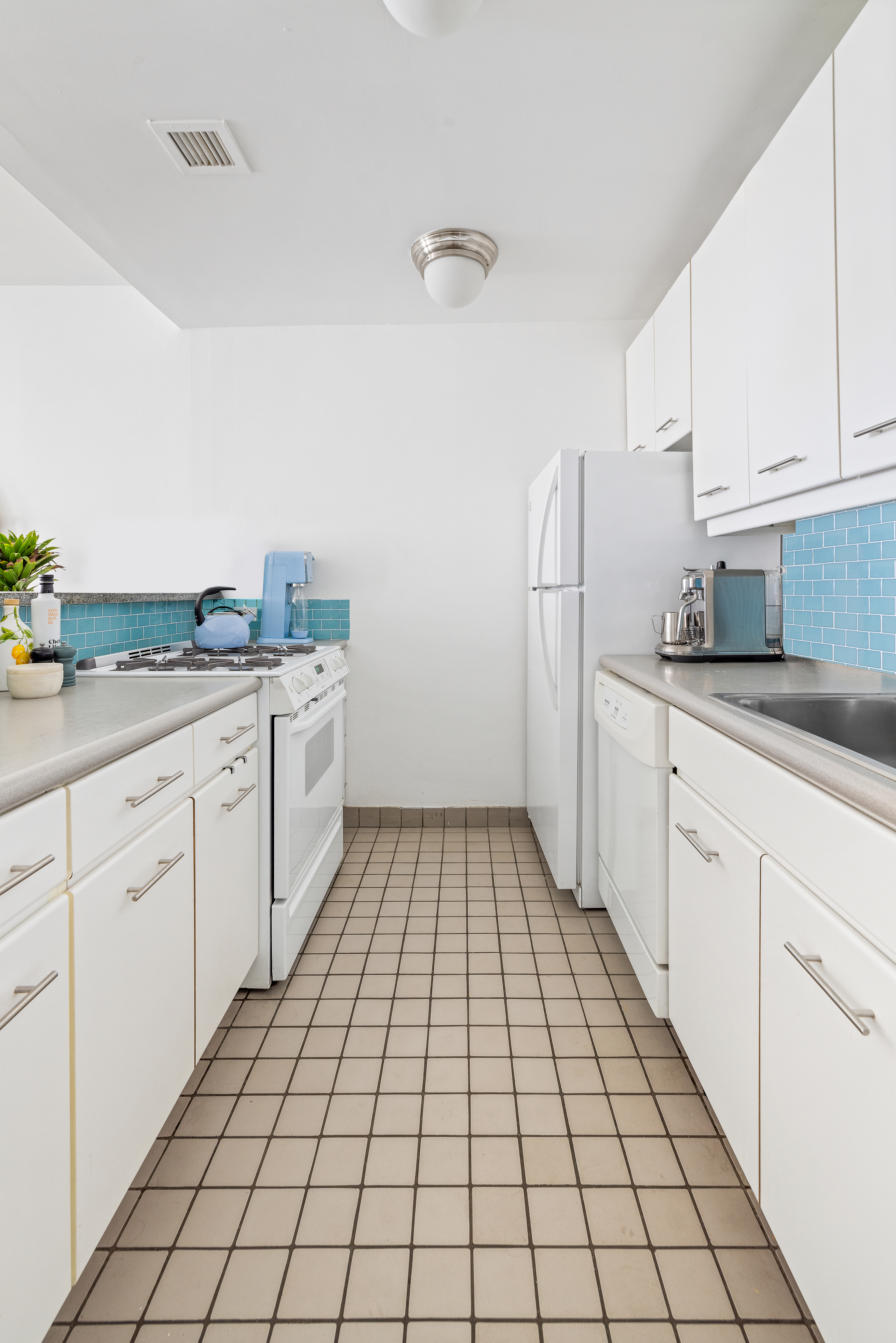 167 Perry Street, Unit 5D Manhattan, NY 10014 - Photo 6 of 18 a kitchen with a sink a stove and refrigerator