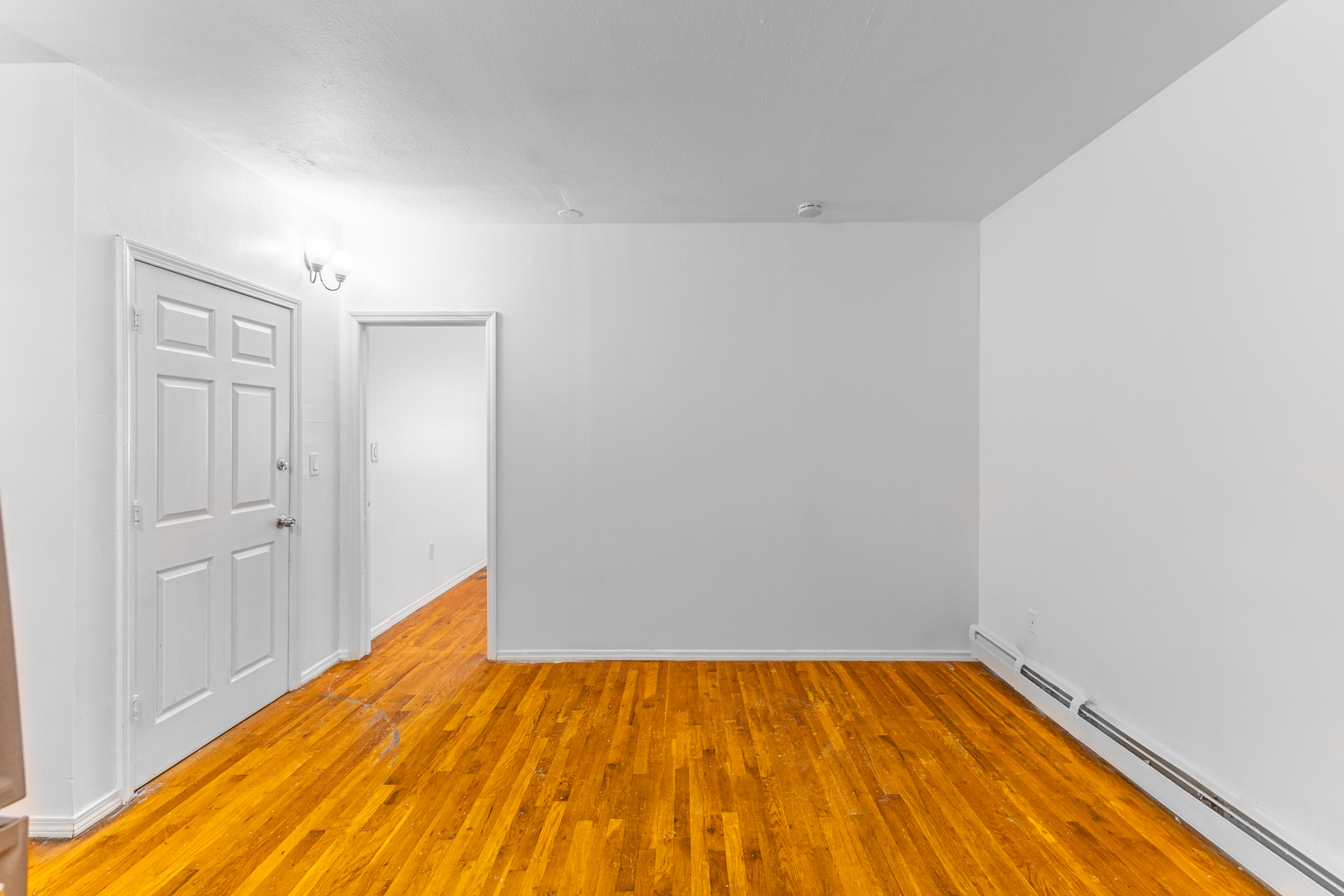 434 Lexington Avenue Brooklyn, NY 11221 - Photo 12 of 22 a view of a room with wooden floor and bench
