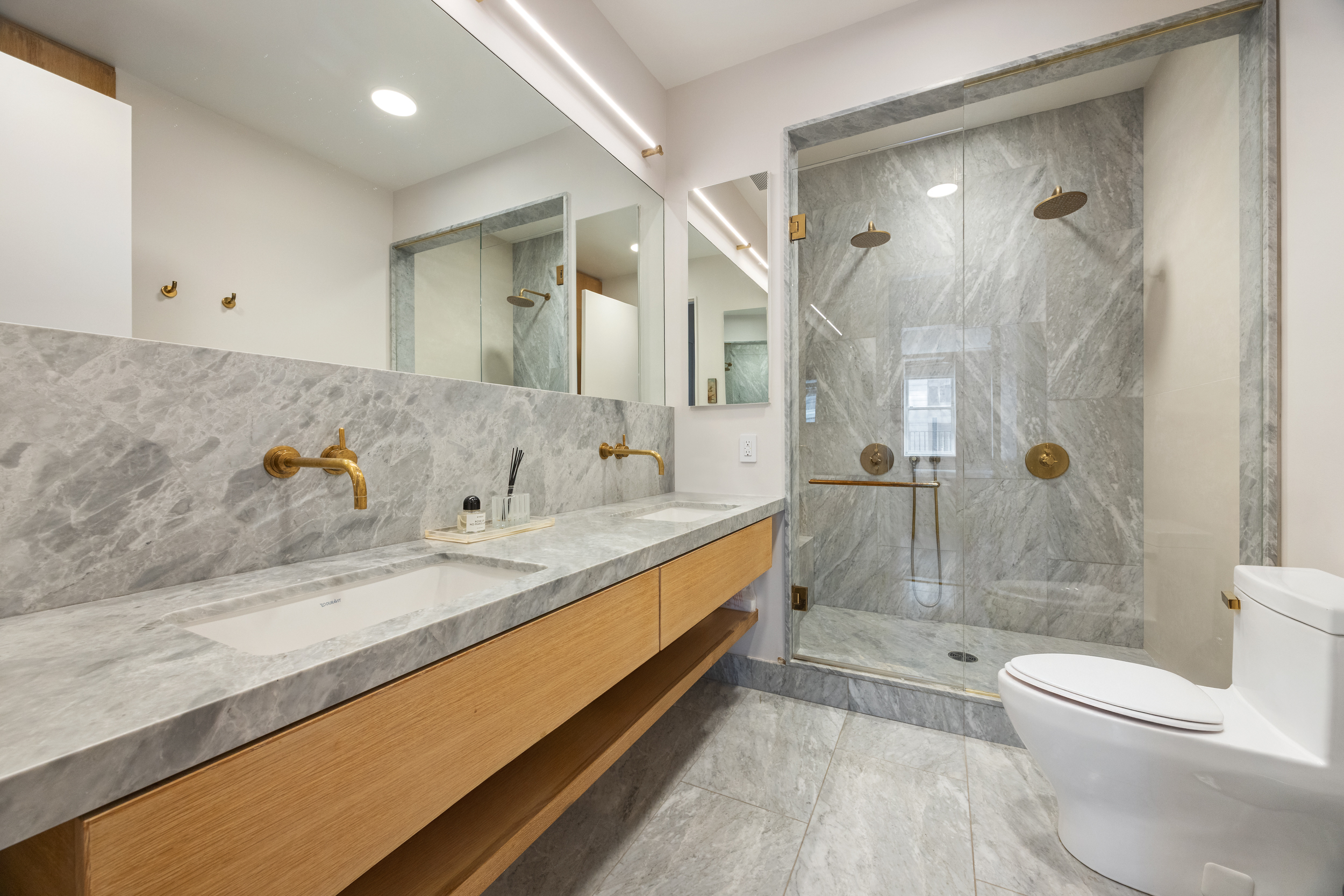 622 Greenwich Street, Unit 4B Manhattan, NY 10014 - Photo 21 of 27 a bathroom with a granite countertop sink a toilet and shower