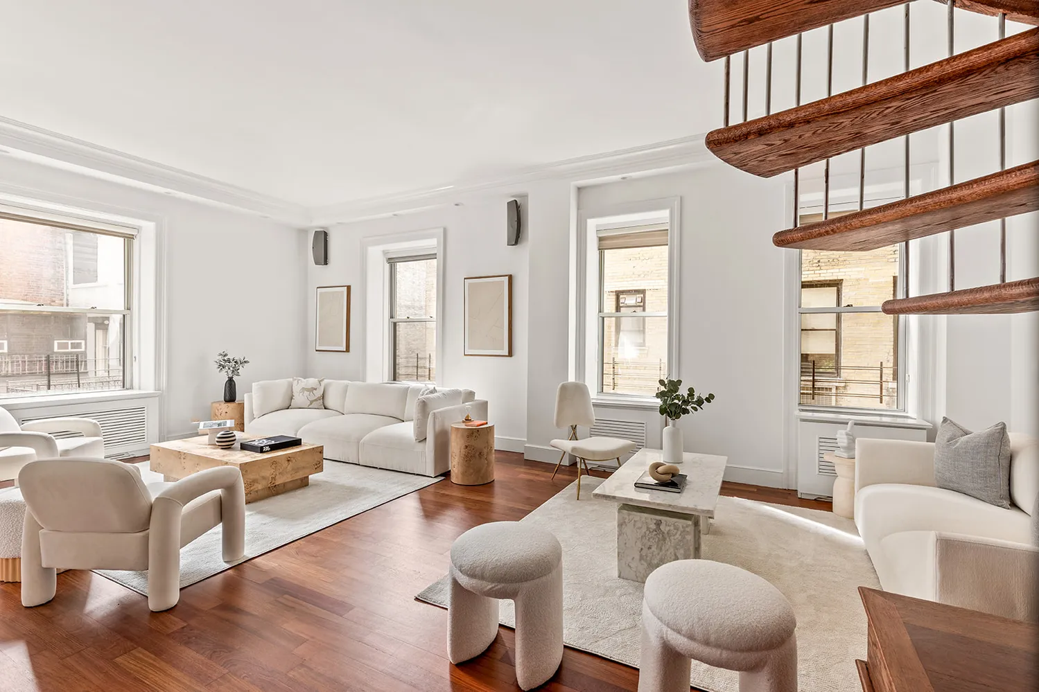 a living room with furniture a fireplace and large windows
