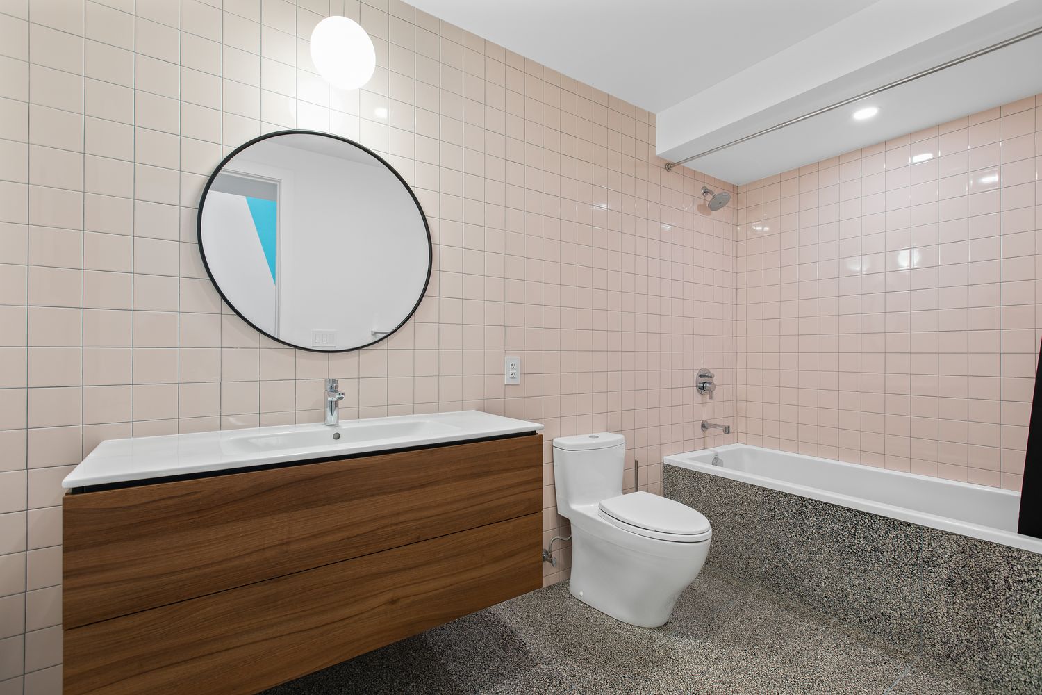 a bathroom with a toilet a sink and a mirror