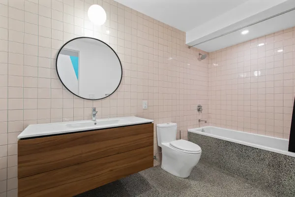 a bathroom with a toilet a sink and a mirror