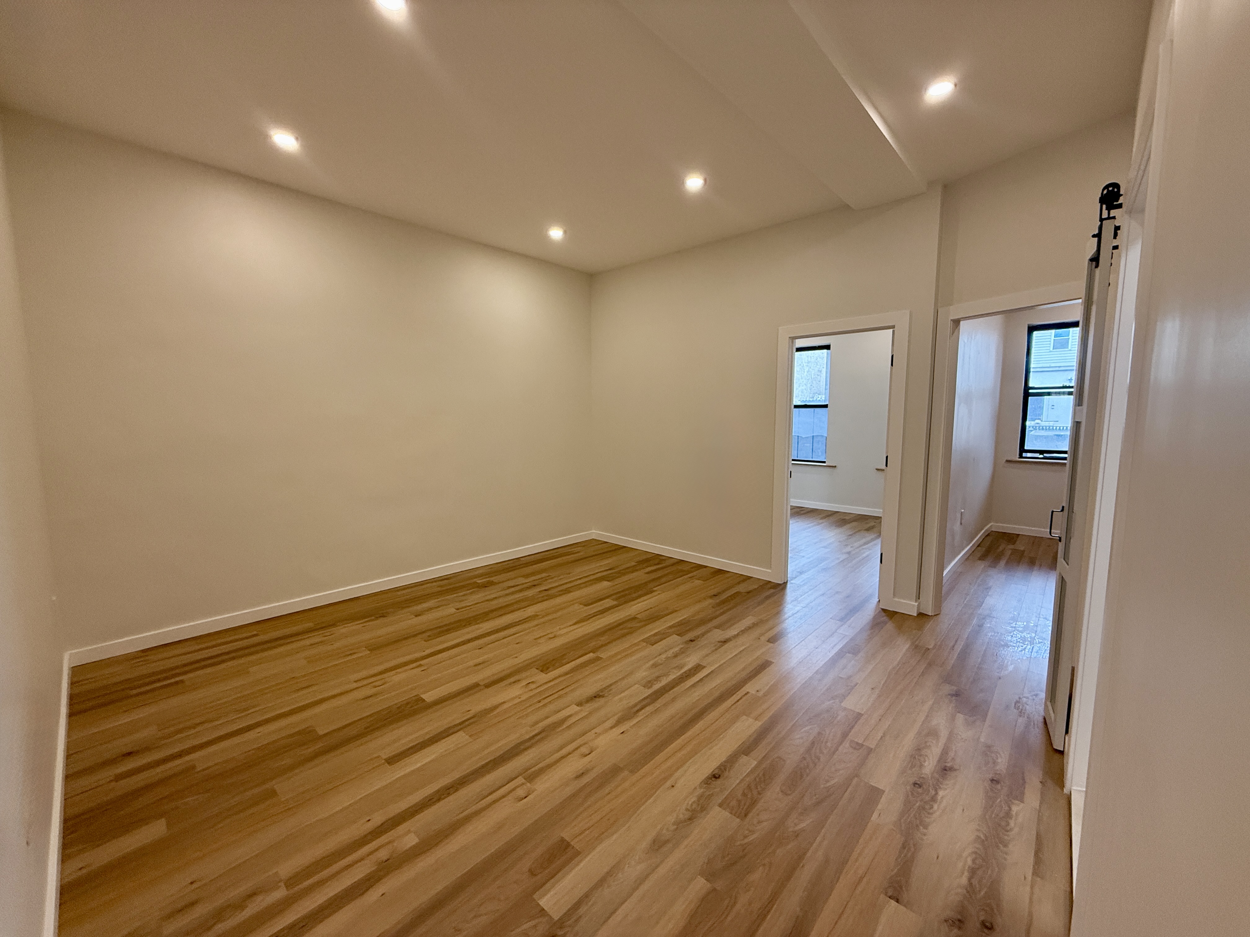 139 Autumn Avenue, Unit 1 Brooklyn, NY 11208 - Photo 7 of 14 wooden floor in an empty room with a window