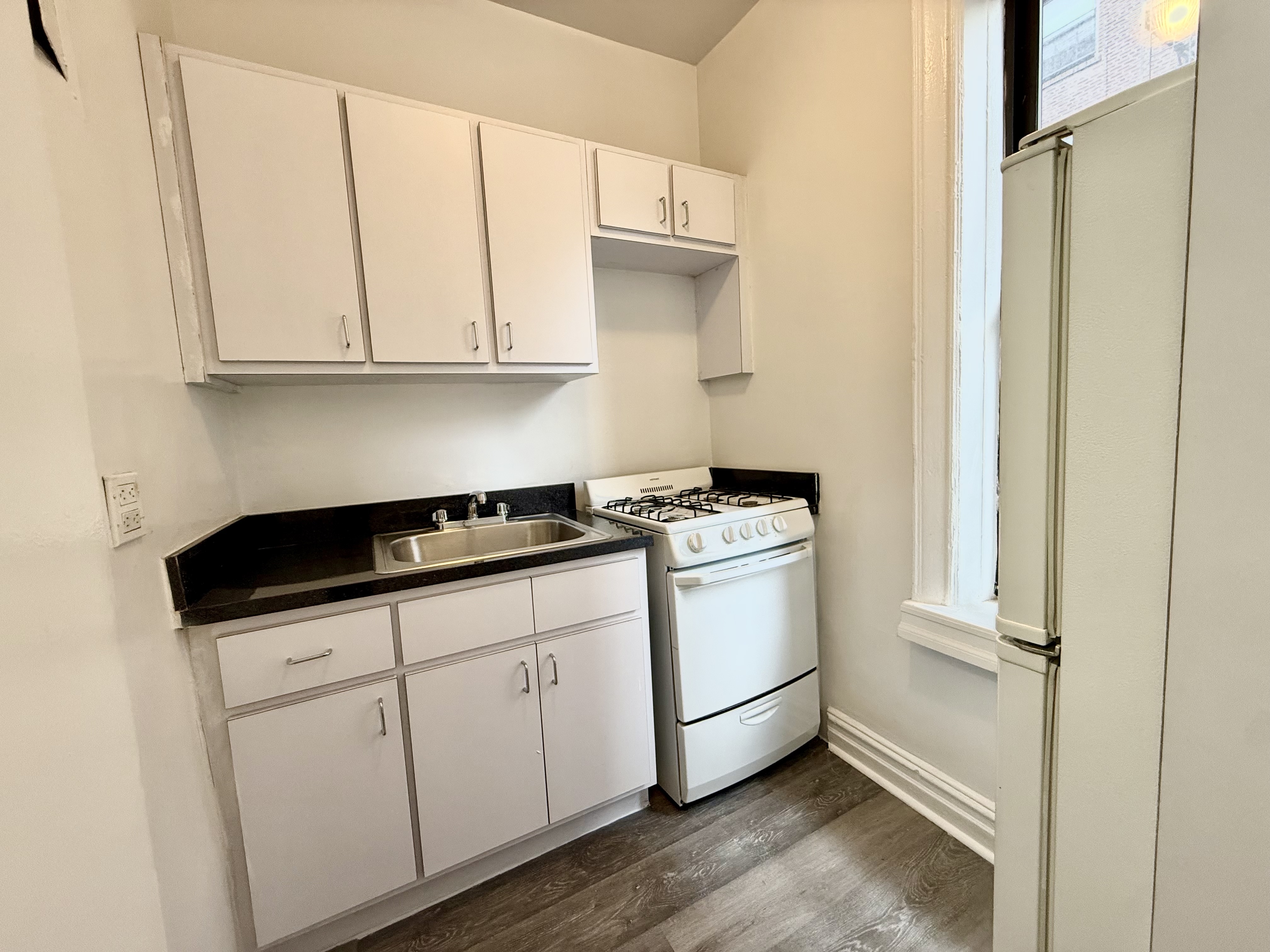 a utility room with sink dryer and washer