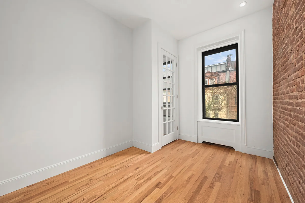 130 West 80th Street, Unit 4F Manhattan, NY 10024 - Photo 2 of 7 an empty room with wooden floor and windows