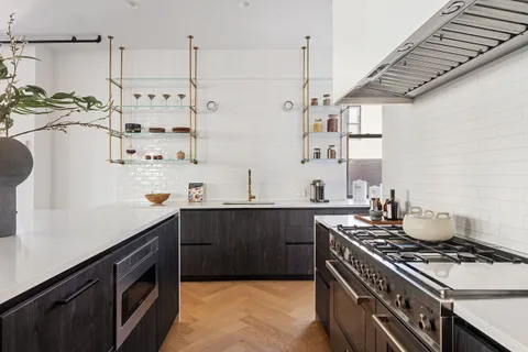 a kitchen with stainless steel appliances a stove a sink and a refrigerator