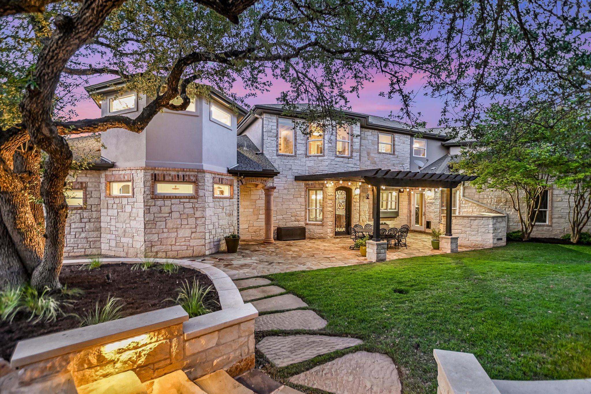 1422 Palomino Ridge Drive Austin, TX 78733 - Photo 43 of 60 a front view of a house with a yard table and chairs