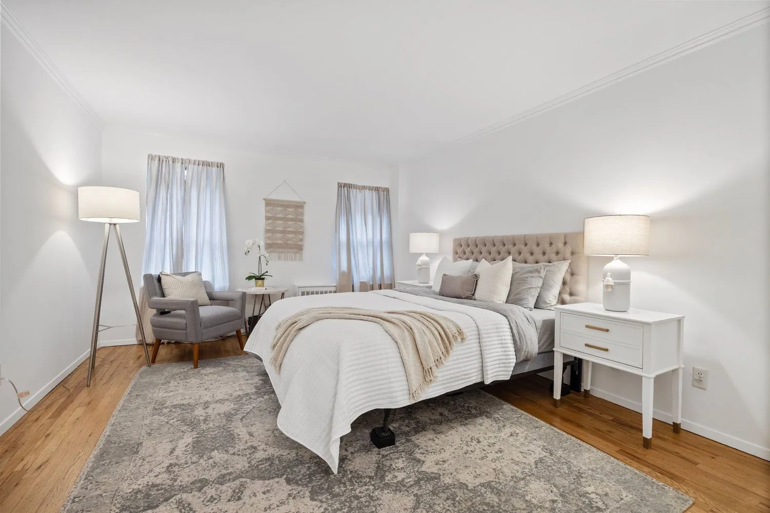 a spacious bedroom with a bed and a lamp