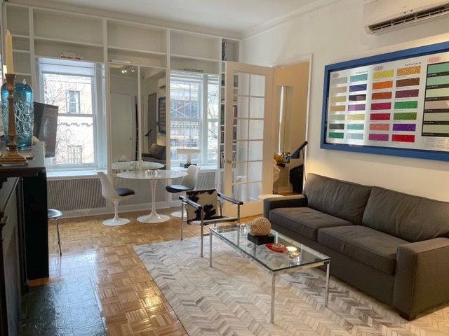 128 East 62nd Street, Unit 4F Manhattan, NY 10065 - Photo 2 of 9 a living room with furniture and a window
