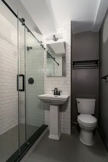 a bathroom with a toilet a sink and shower