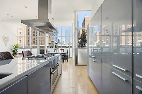 a kitchen with stainless steel appliances granite countertop a stove and a sink