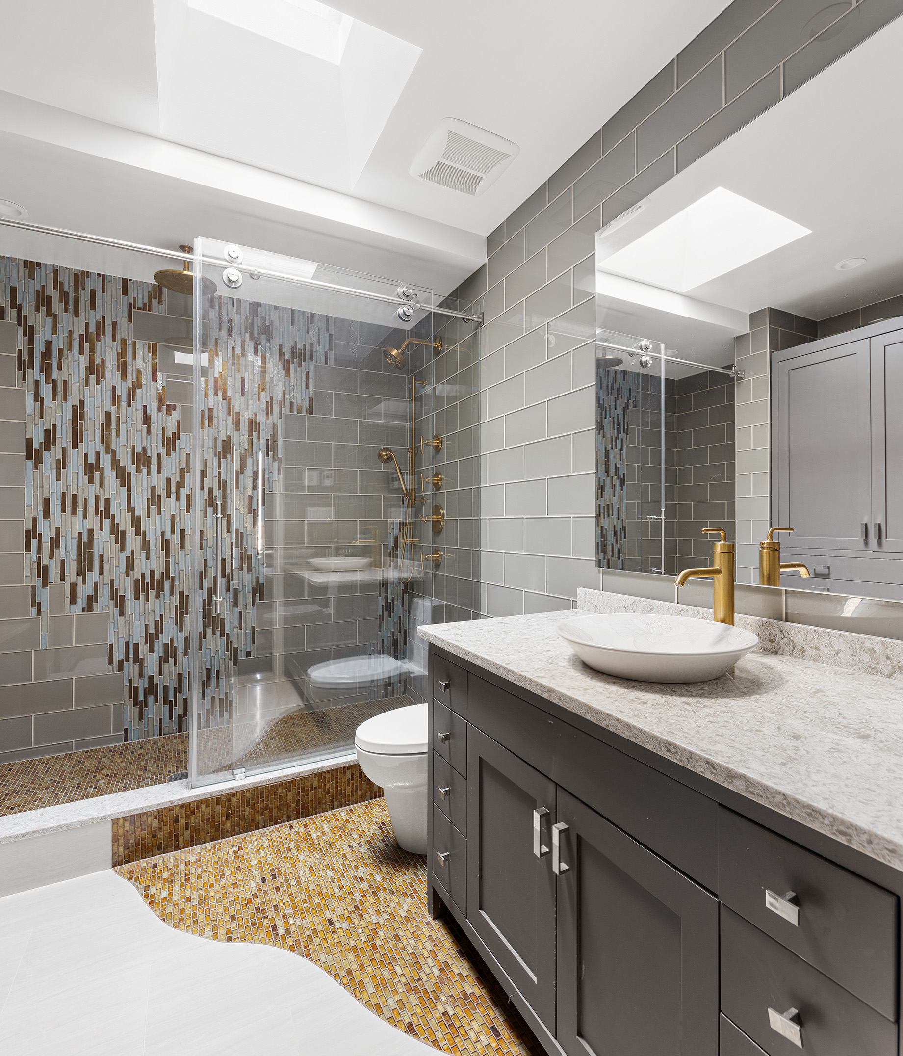 252 7th Avenue, Unit PHG Manhattan, NY 10001 - Photo 17 of 27 a bathroom with a granite countertop sink toilet and shower