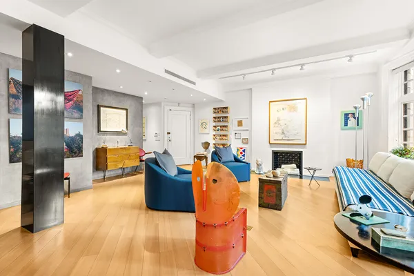 a living room with furniture gym equipment and a window