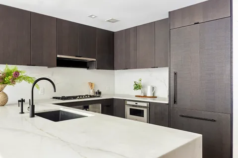 a kitchen with a sink stove and cabinets