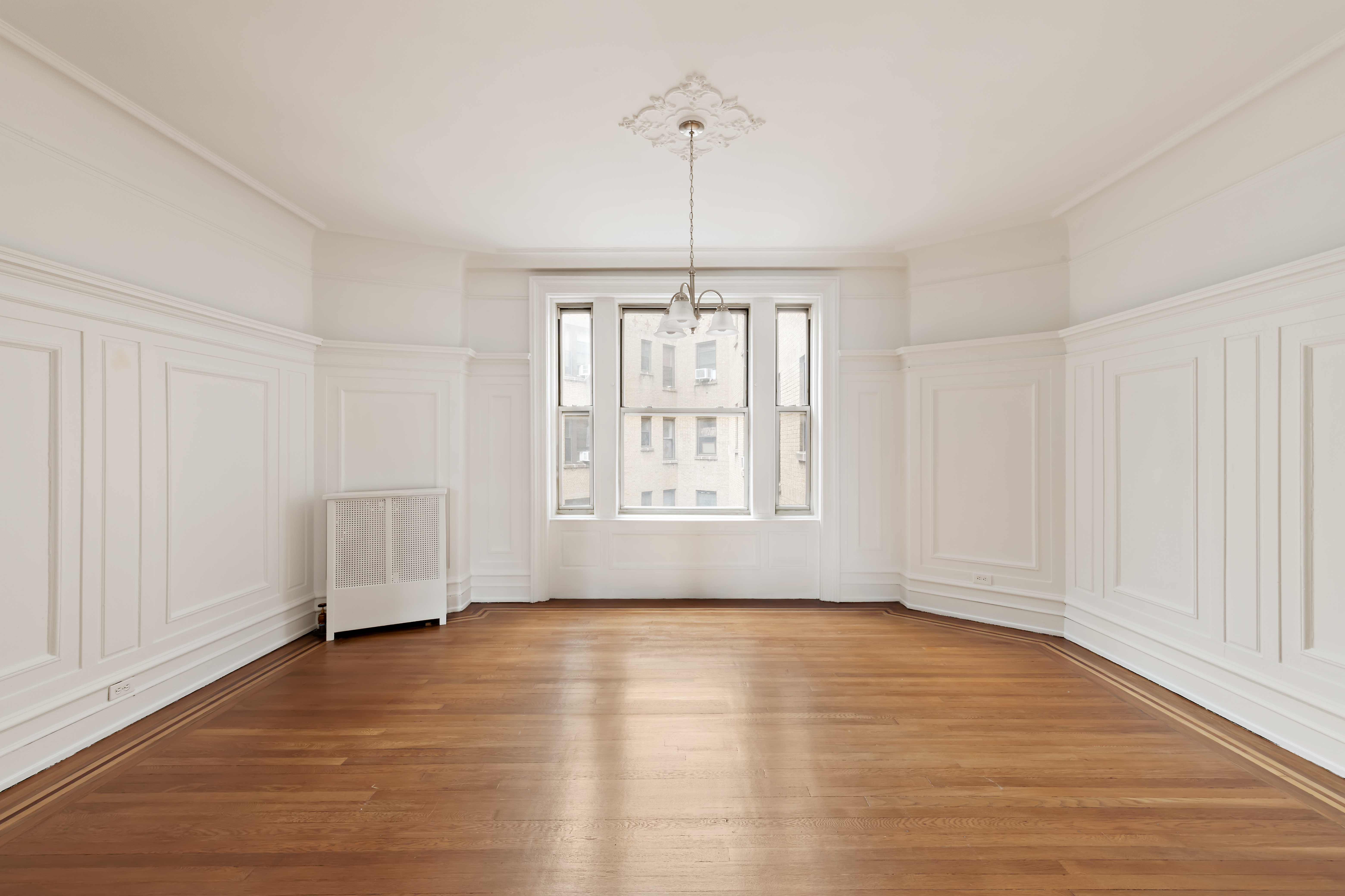 800 Riverside Drive, Unit 6E Manhattan, NY 10032 - Photo 6 of 30 a view of an empty room with glass window and hardwood floor