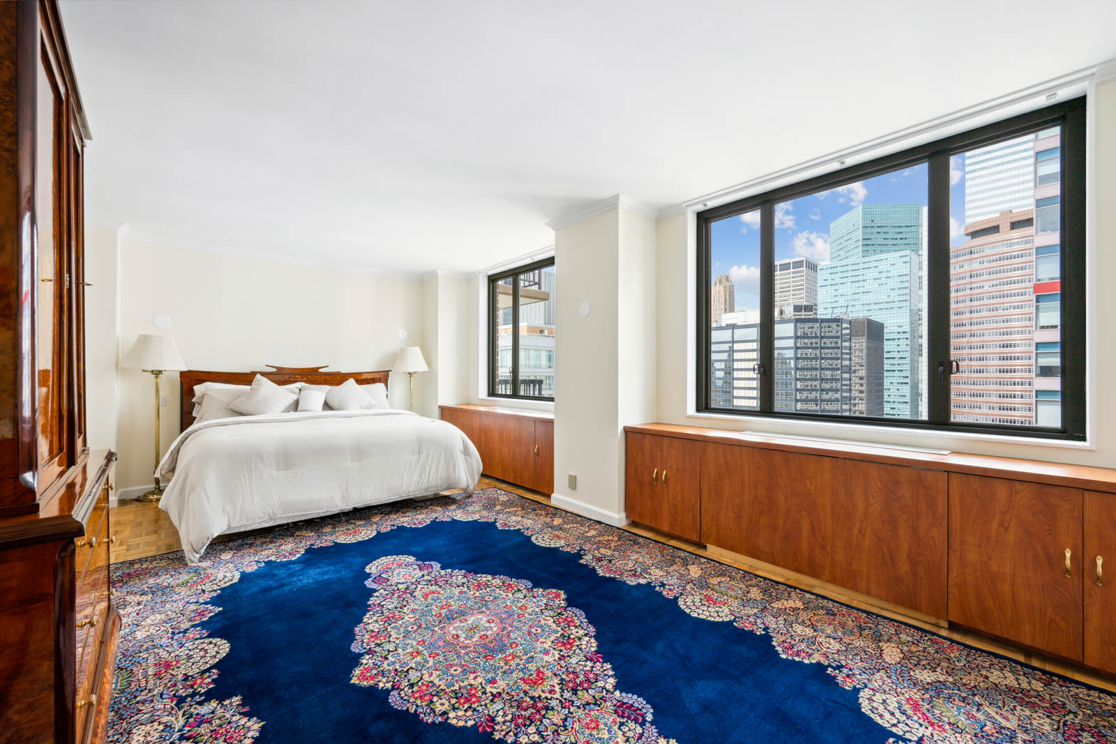300 East 54th Street, Unit 34GF Manhattan, NY 10022 - Photo 4 of 16 a bedroom with a bed and wooden floor