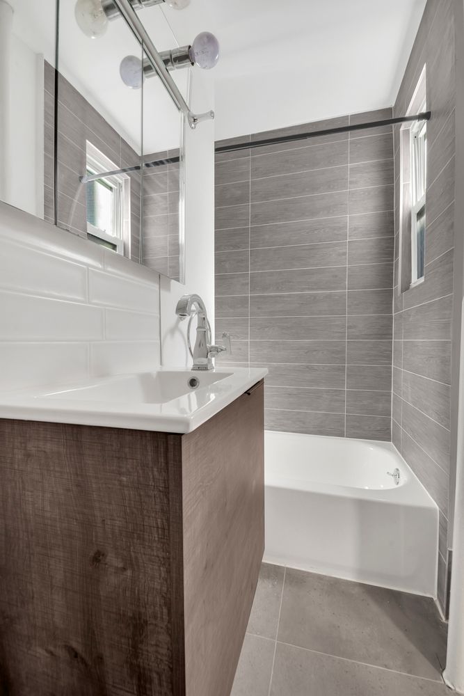 7001 Shore Road, Unit 2 Brooklyn, NY 11209 - Photo 12 of 17 a bathroom with a sink and a bathtub