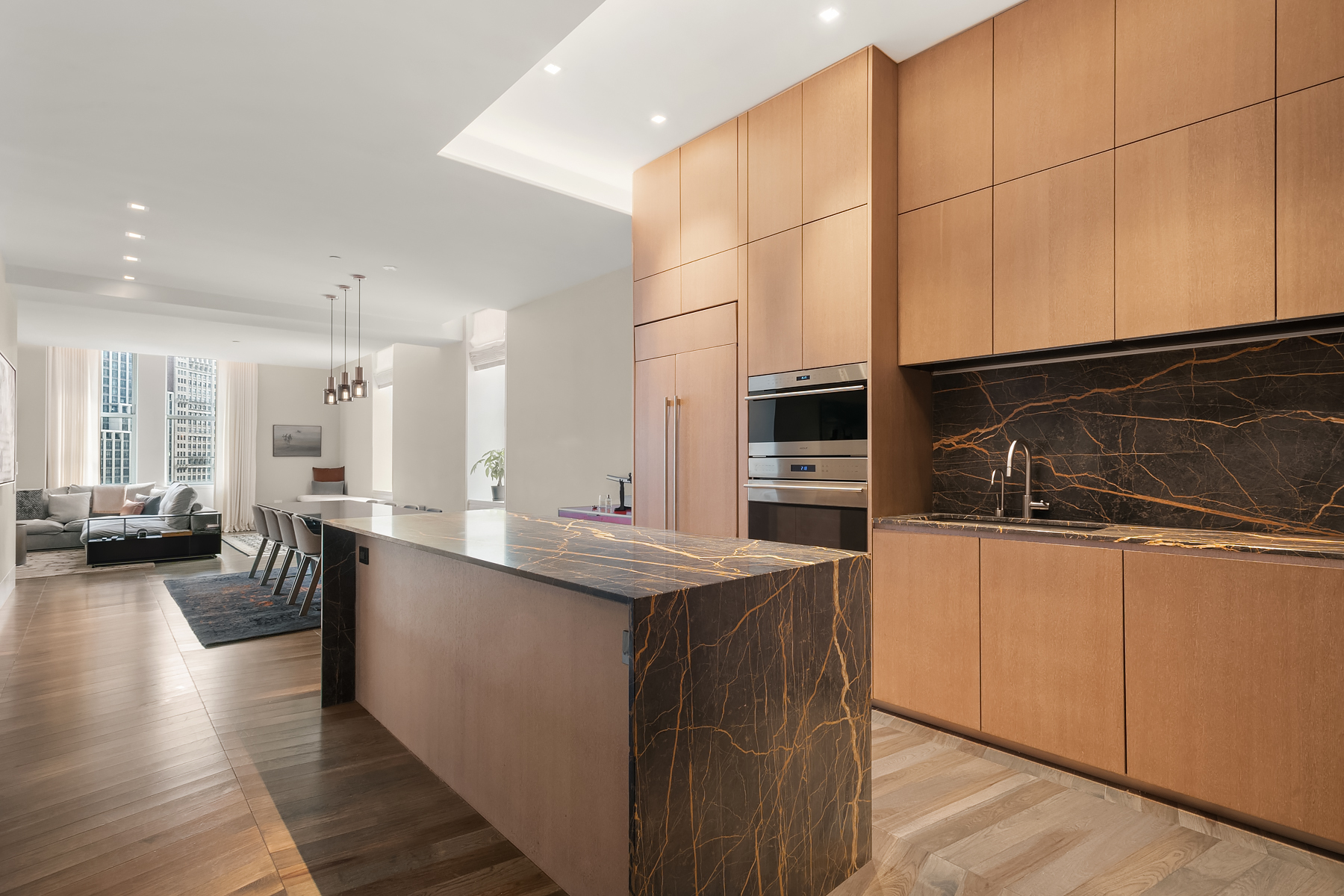 49 Chambers Street, Unit 11D Manhattan, NY 10007 - Photo 5 of 30 a kitchen with stainless steel appliances kitchen island granite countertop a stove a sink and a microwave