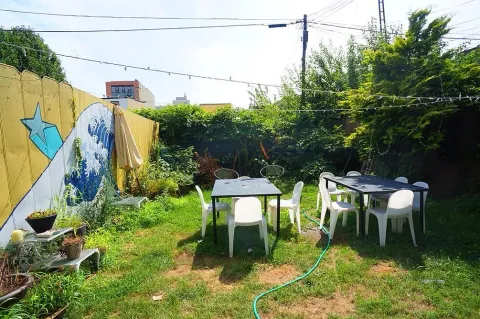 a backyard of a house with table and chairs