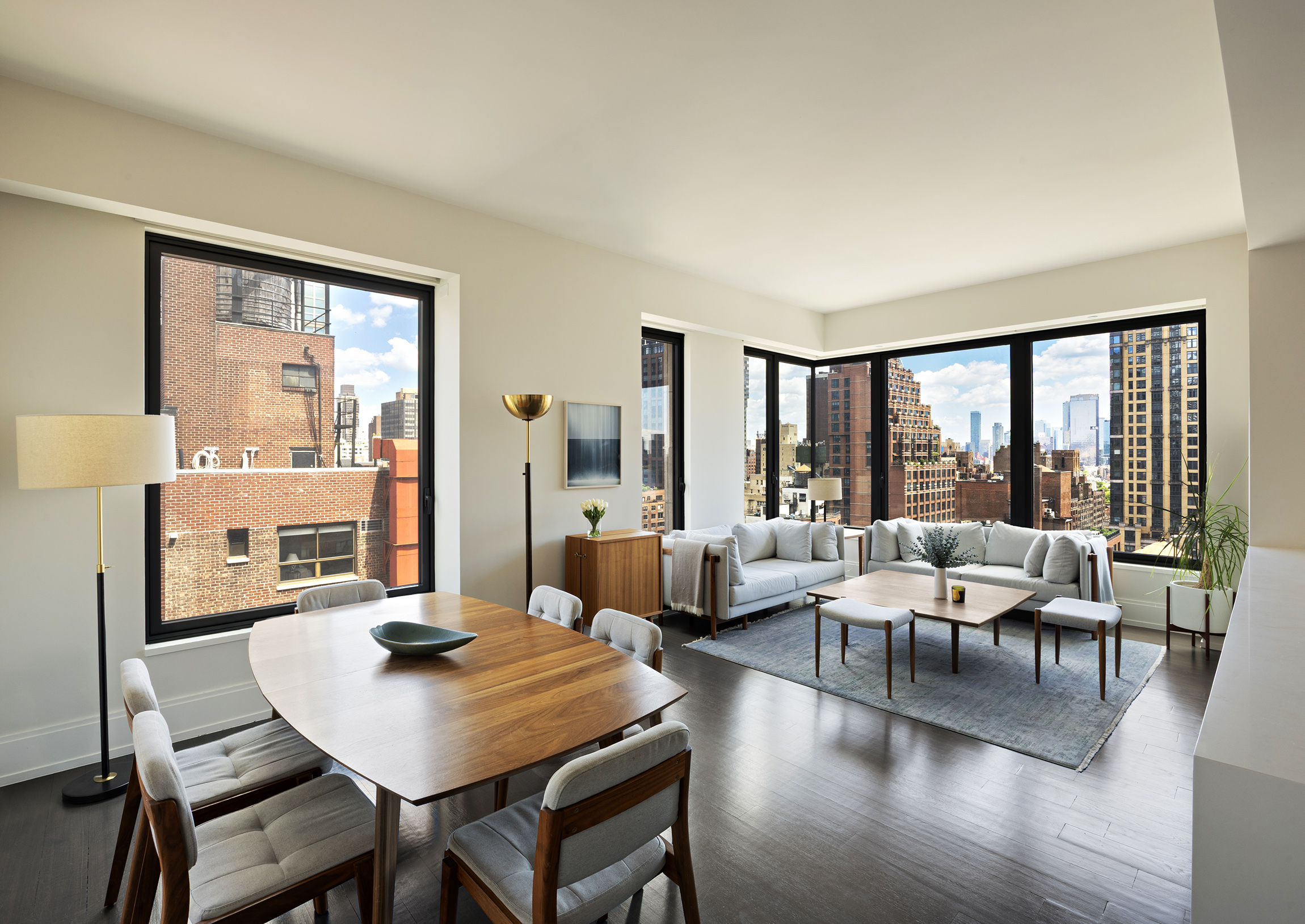 301 East 50th Street, Unit 16B Manhattan, NY 10022 - Photo 2 of 15 a living room with furniture and a large window