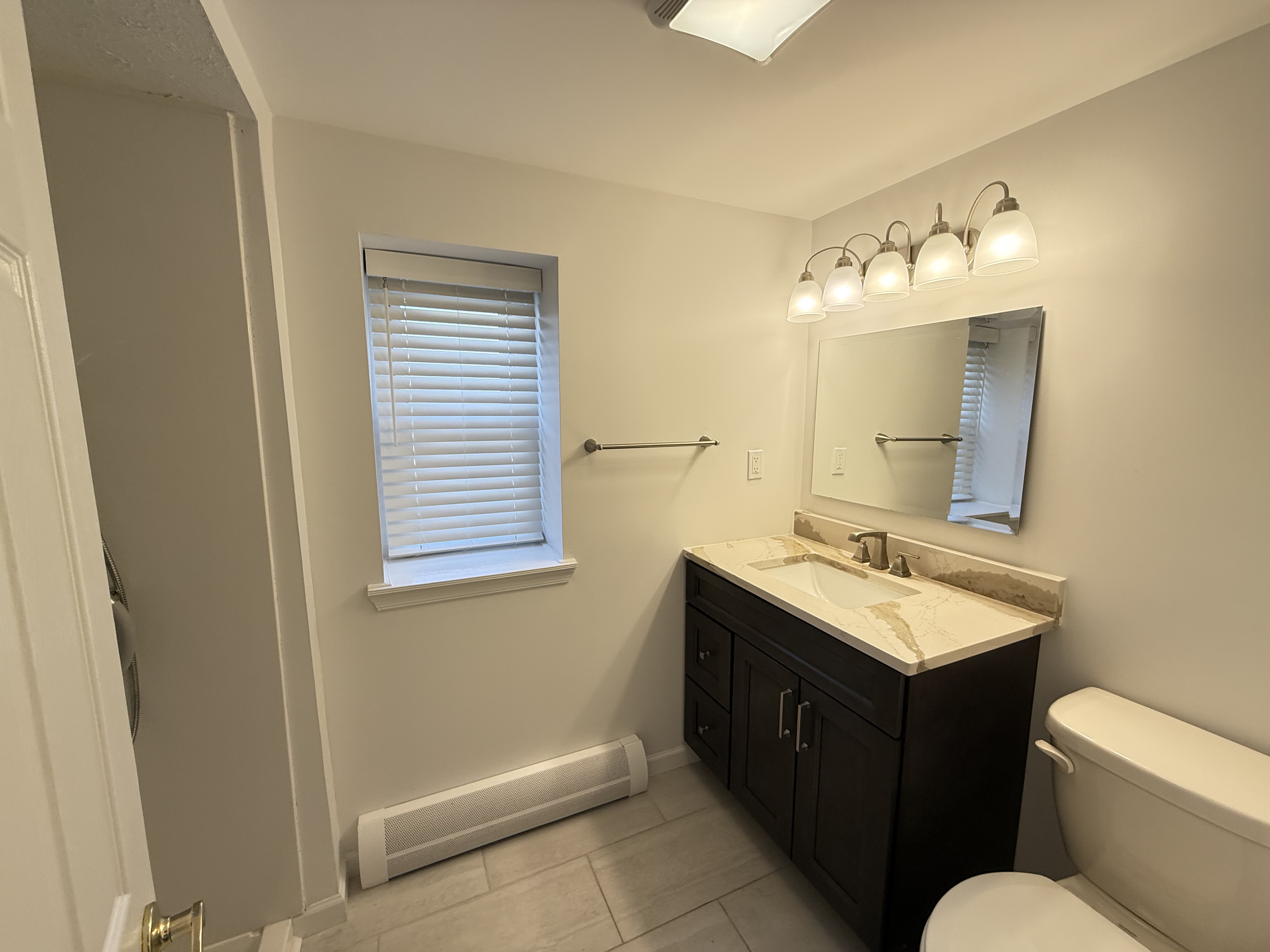 3236 Country Club Road Bronx, NY 10465 - Photo 17 of 22 a bathroom with a double vanity sink mirror and toilet