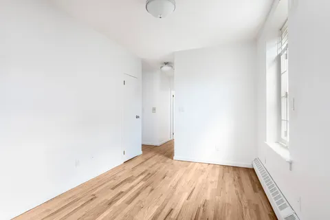 a view of a room with wooden floor and white walls