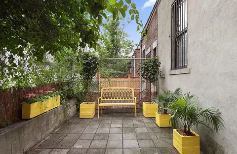 a view of a chairs and table in the patio with a fire pit
