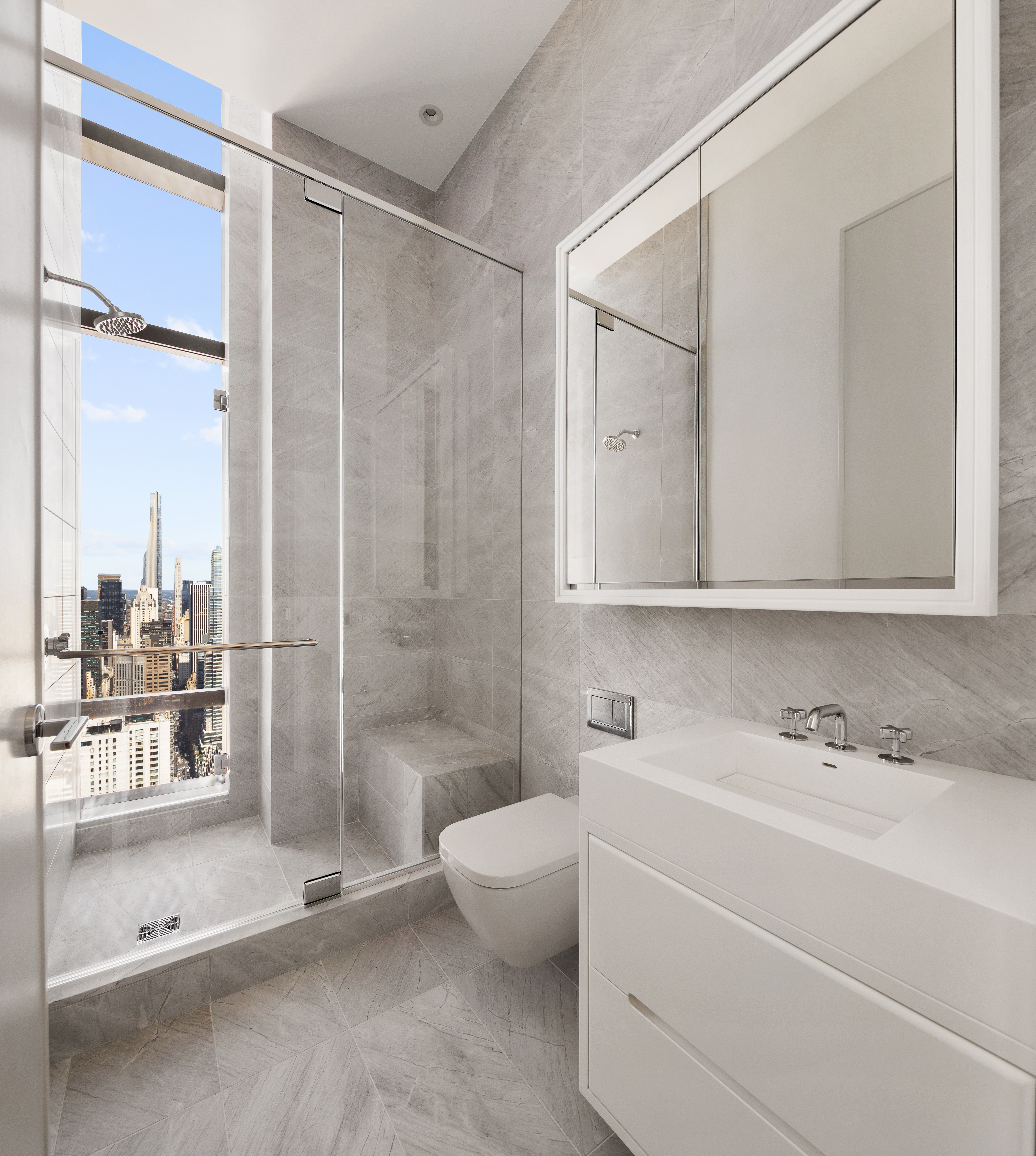 430 East 58th Street, Unit PH71 Manhattan, NY 10022 - Photo 13 of 26 a bathroom with a shower a sink and a mirror