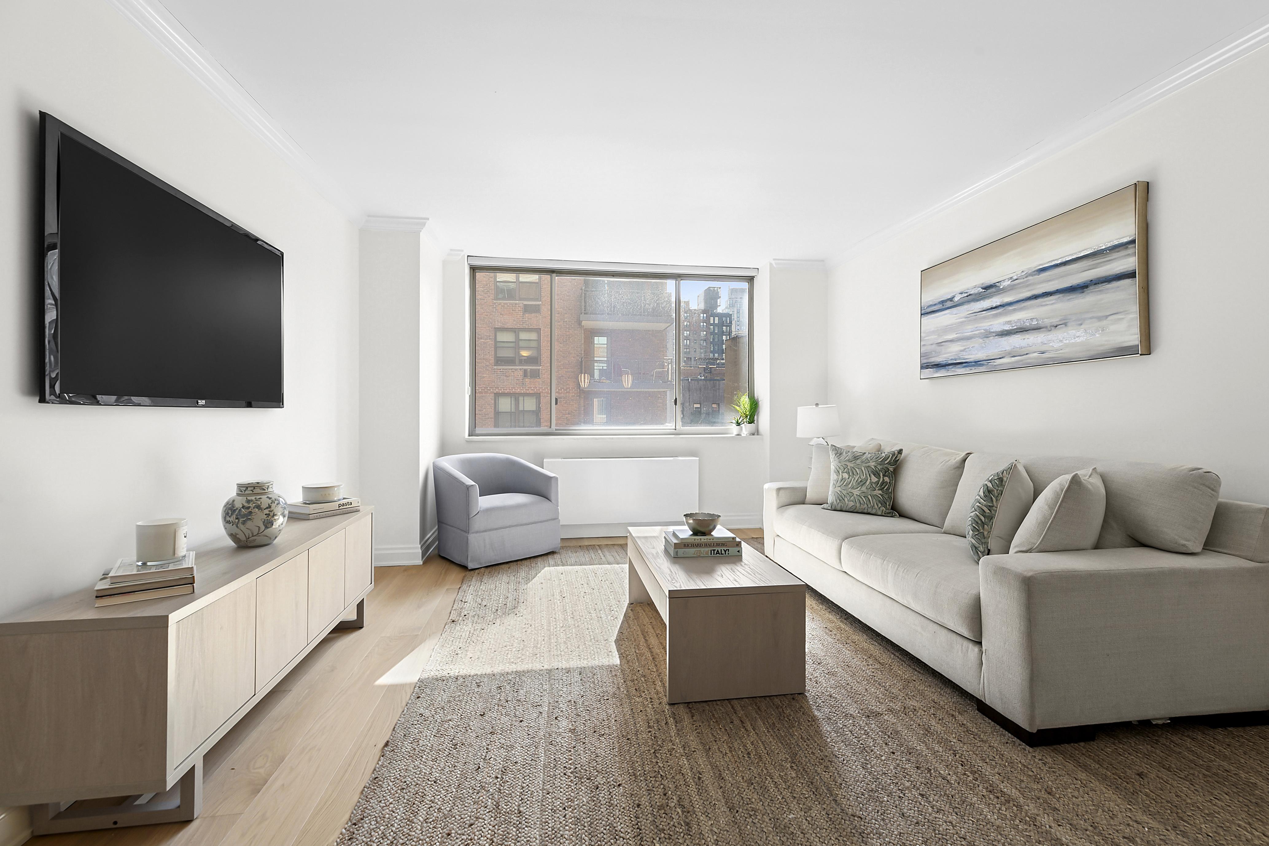 350 East 82nd Street, Unit 4C Manhattan, NY 10028 - Photo 1 of 13 a living room with furniture and a flat screen tv