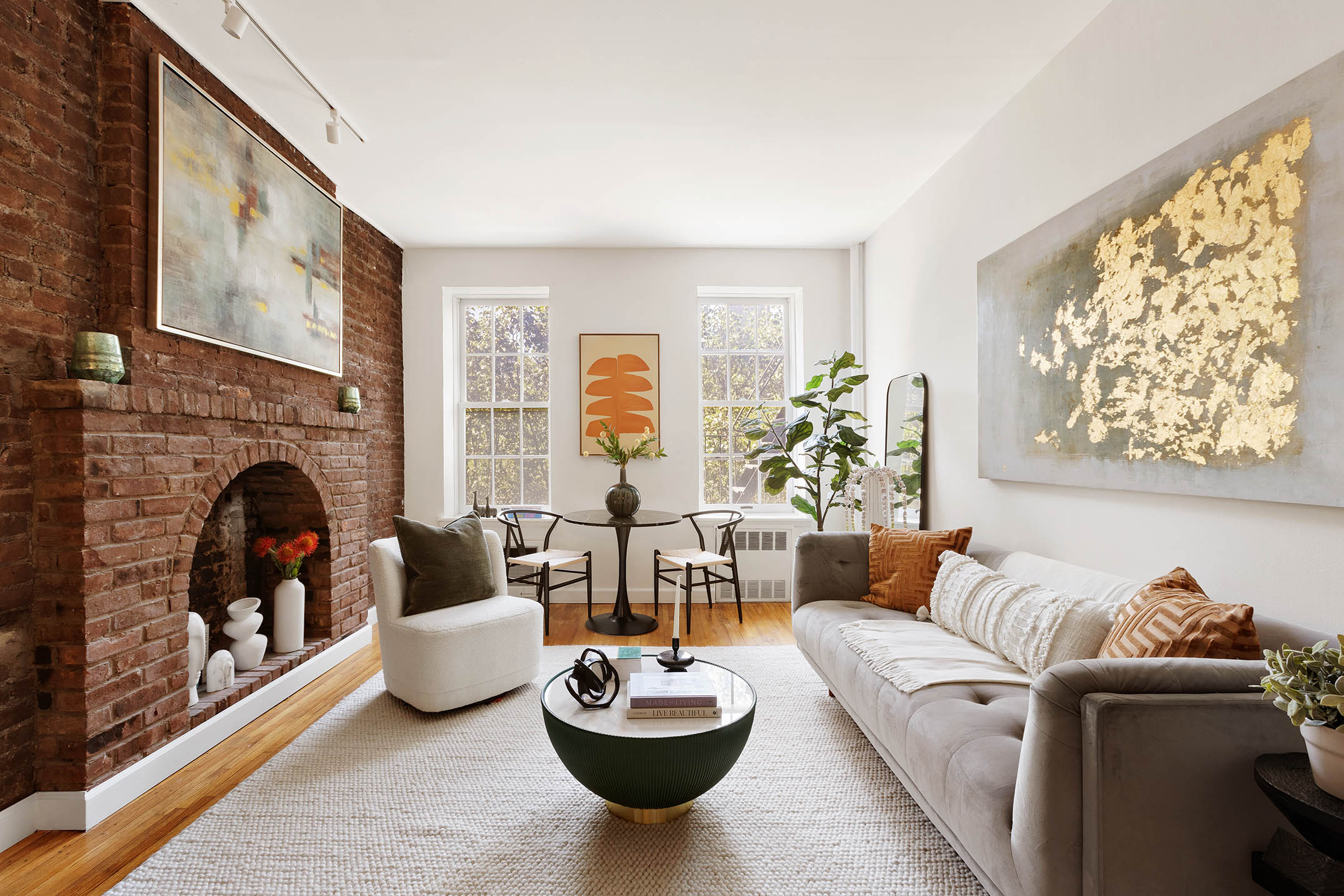 a living room with furniture potted plant and a fireplace