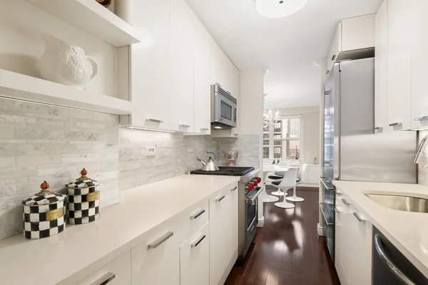 a kitchen with a sink stove and cabinets