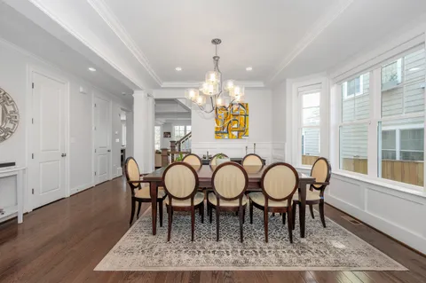 a living room with furniture kitchen and a large window