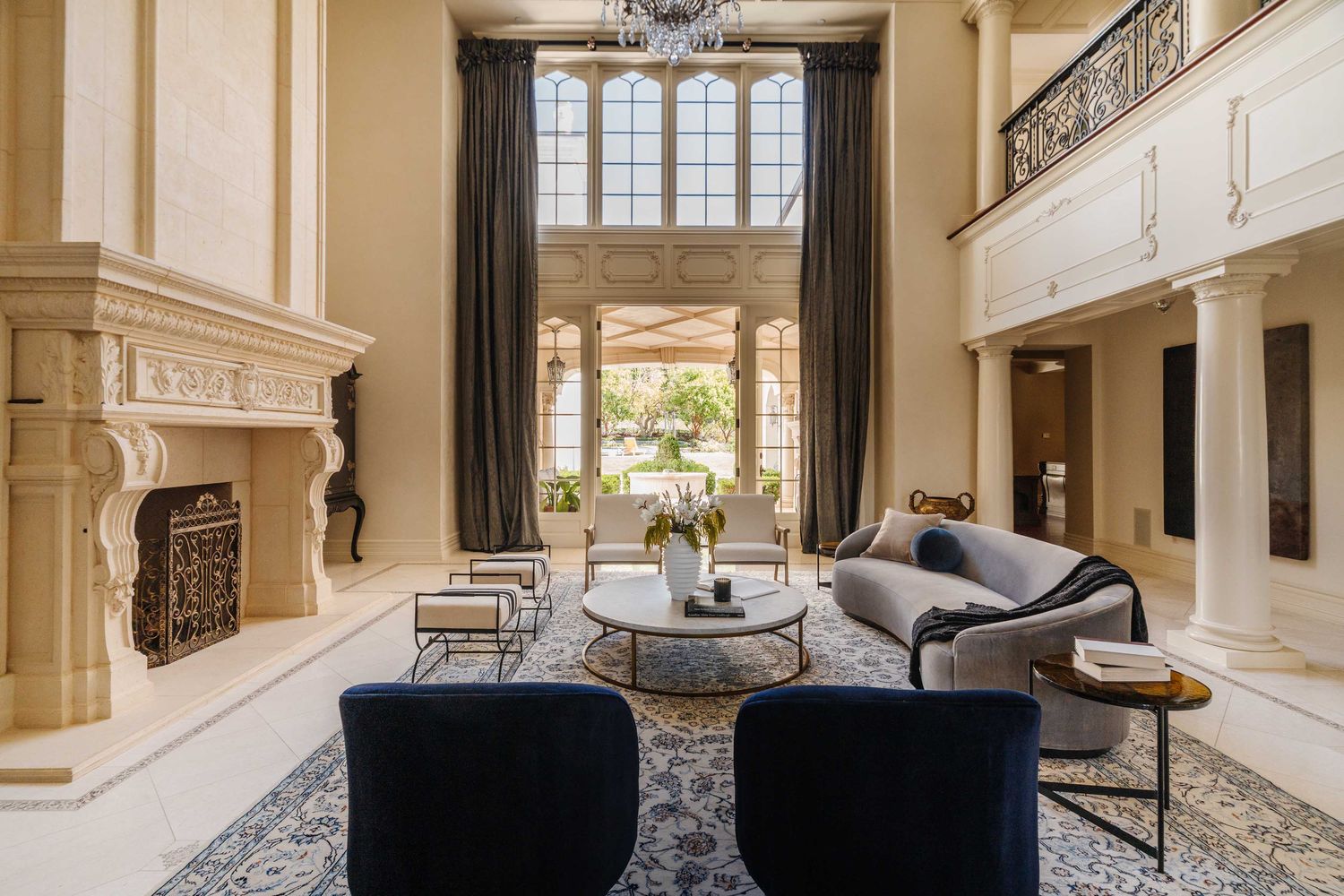 a living room with fireplace furniture and a floor to ceiling window