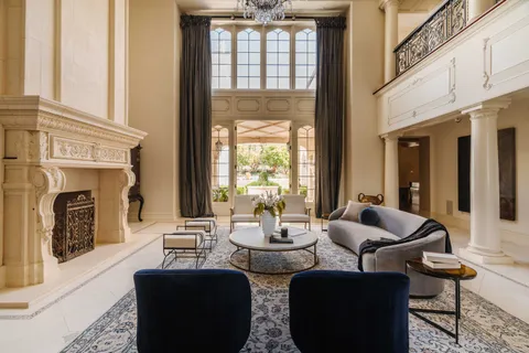 a living room with fireplace furniture and a floor to ceiling window