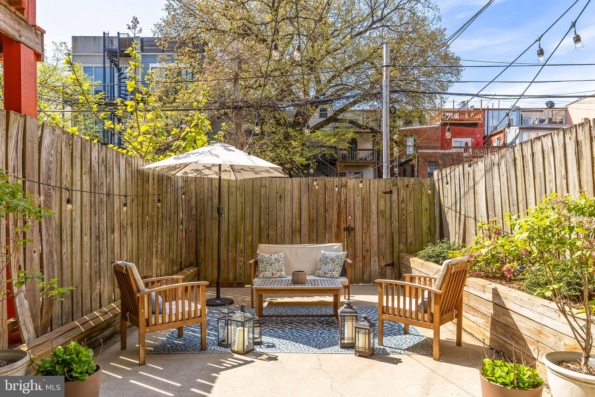 1354 Kenyon Street Northwest, Unit G Washington, DC 20010 - Photo 35 of 37 a backyard of a house with barbeque oven table and chairs